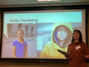 Zoe Clemmons presenting on climate change with a picture of Greta Thunberg on the powerpoint.