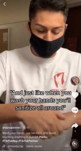 Student sanitizes his hands.