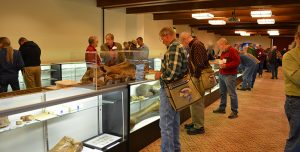 Odyssey Conference attendees looking at artifacts