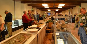 Wide shot of Odyssey Conference attendees looking at artifacts