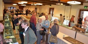 Wide shot of Odyssey Conference attendees looking at artifacts