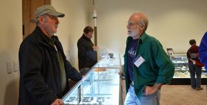 Odyssey Conference attendees talking over artifacts display