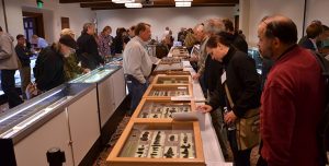 Odyssey Conference attendees looking at artifacts
