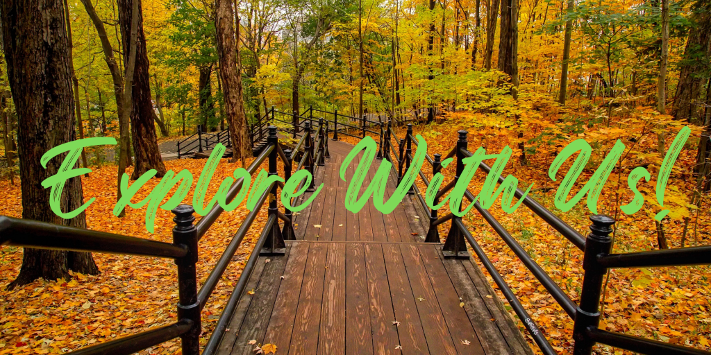 Autumn trees and wooden walkway with title of explore with us