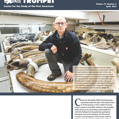 April 2024 Mammoth Trumpet cover of Matthew Wooler in his lab with mammoth tusks.