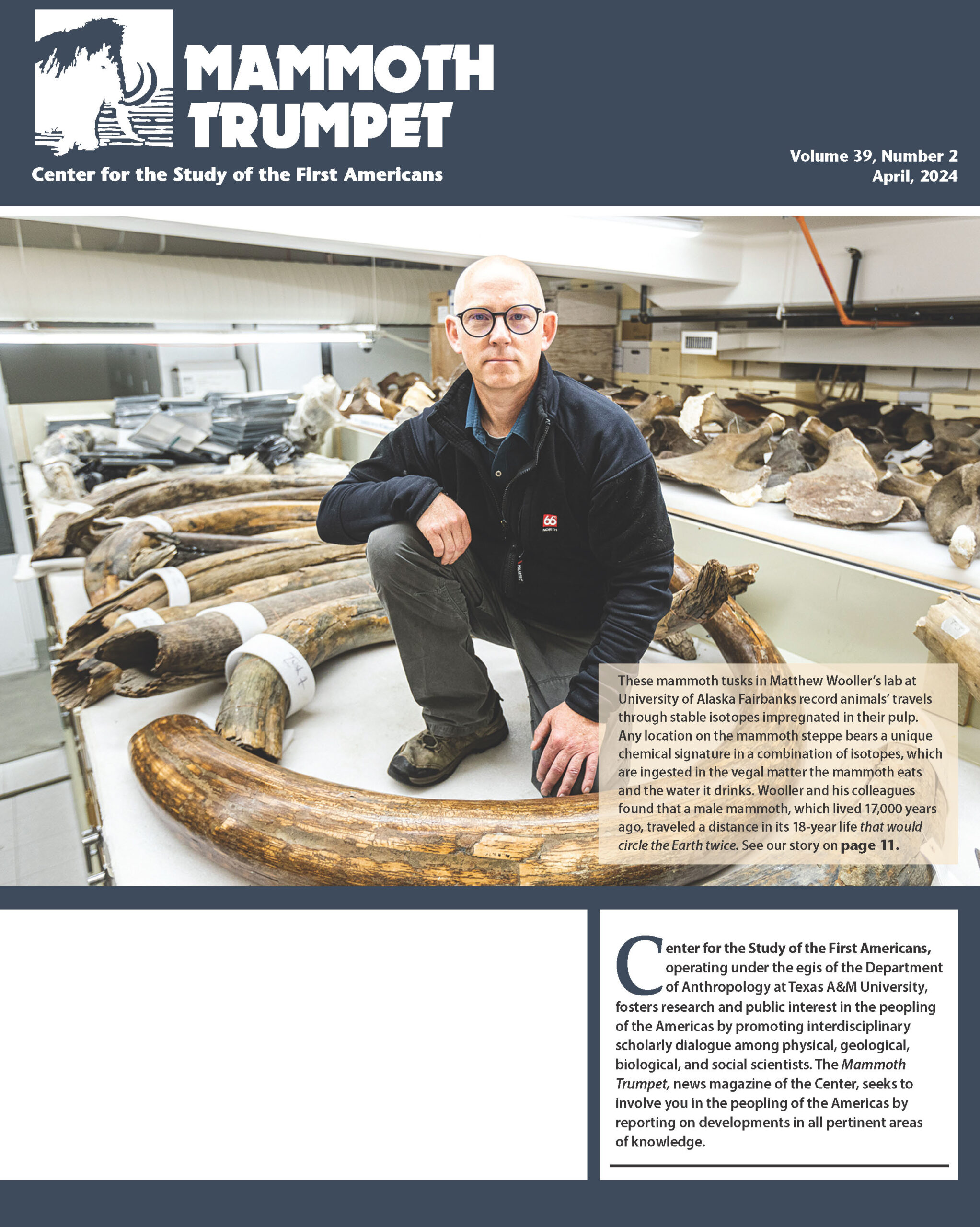 April 2024 Mammoth Trumpet cover of Matthew Wooler in his lab with mammoth tusks.