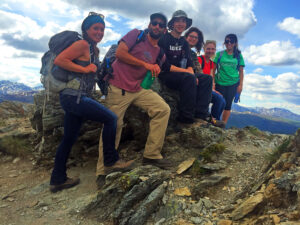 group of male and female students on mountain top