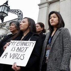 Asian American women protesting racial violence.