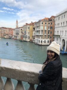 Student standing on bridge in Venice, Italy during summer study abroad program.