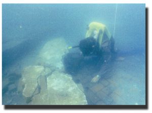 diver examining patterned bricks underwater