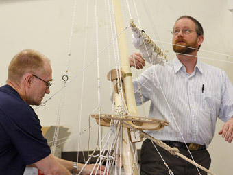Olof Pipping and Dr. Fred Hocker supervising the hoisting of the main topsail yard.
