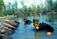 divers near the remains of a ship in the lake