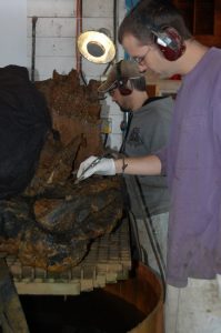 Two conservators work on different areas.