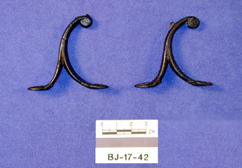 A pair of cast iron hooks recovered from the crate.