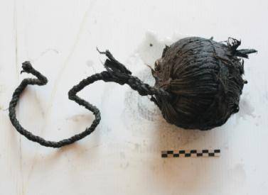 The intact ball of cordage after removal. Both the cordage and tompion are being dehydrated in a series of ethanol and acetone-based baths.