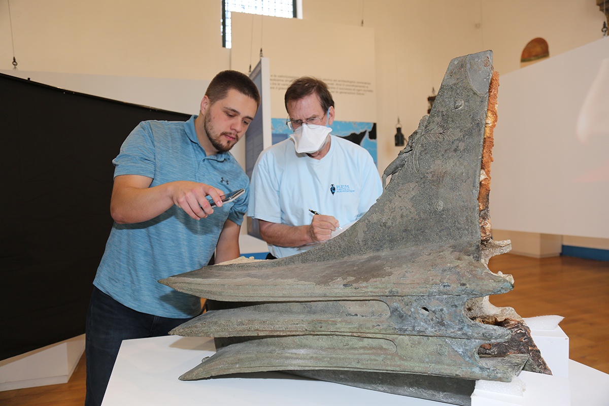 Stephen DeCasien (left) in Sicily studying a naval ram from the Battle of Egadi Islands Project in summer 2022