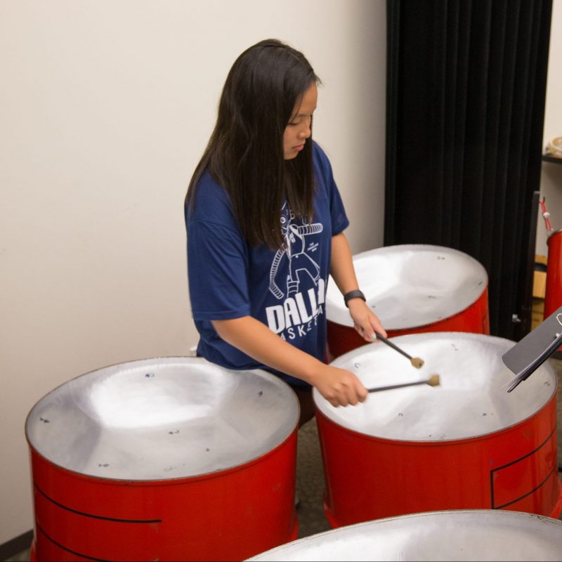 Woman playing steel pans