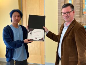 InJoon Seo being presented his award by Dr. Peterson.
