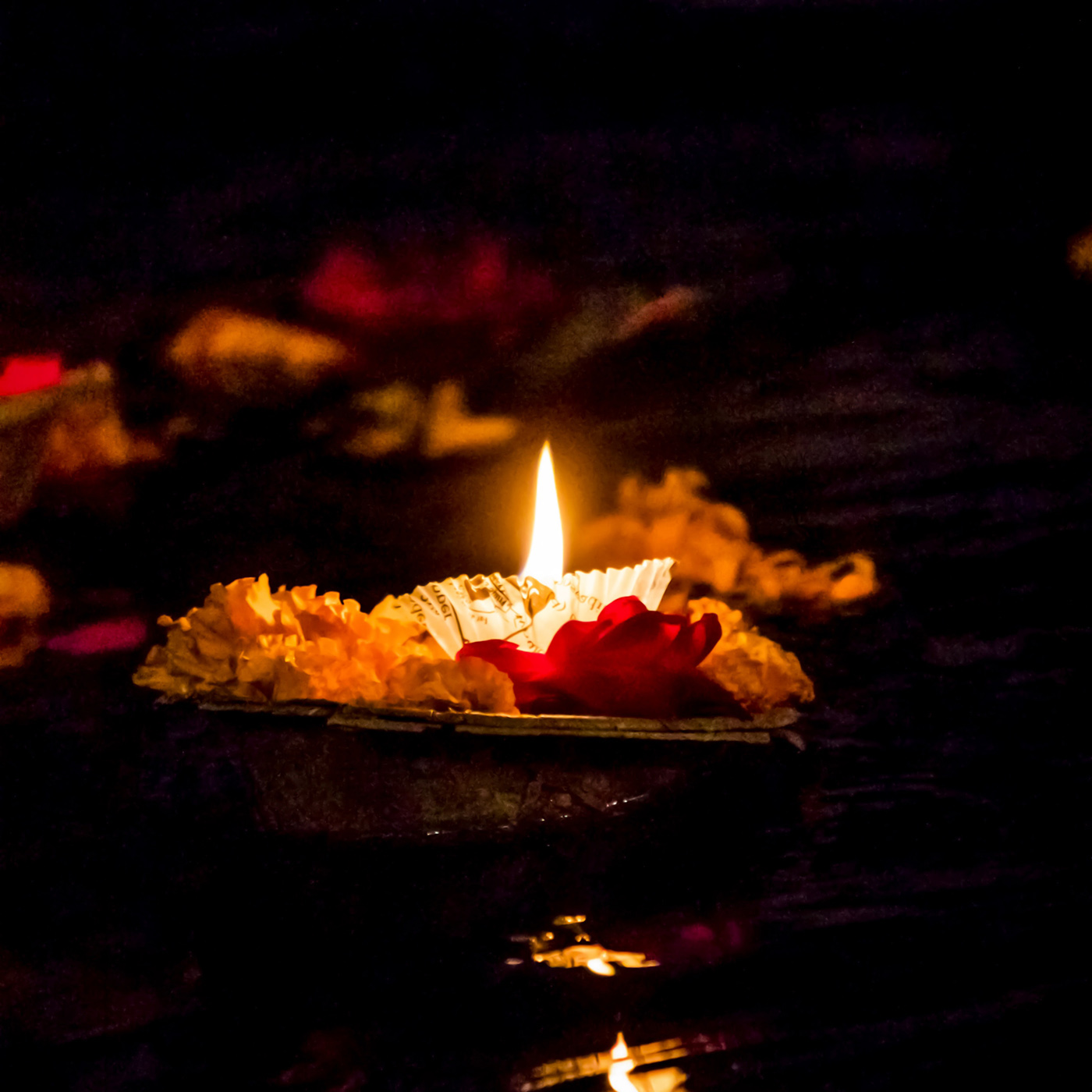 Candle floatin on water at night