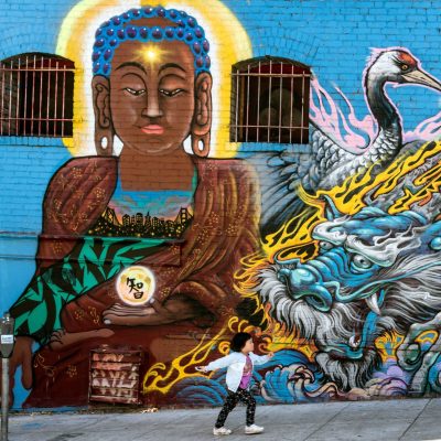 colorful asian art wall mural with asian american child in front of it