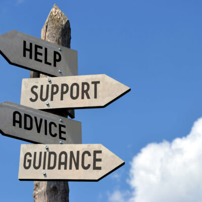 directional signs at a crossroad reading: help, support, advice, and guidance
