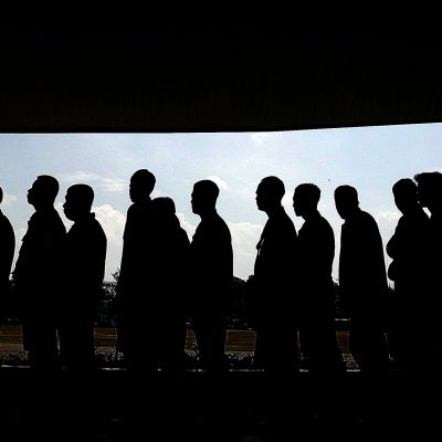 a line of people in silhouette