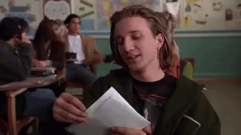 Gif from movie "Clueless" where Travis receives his report card and has a tantrum at his desk.