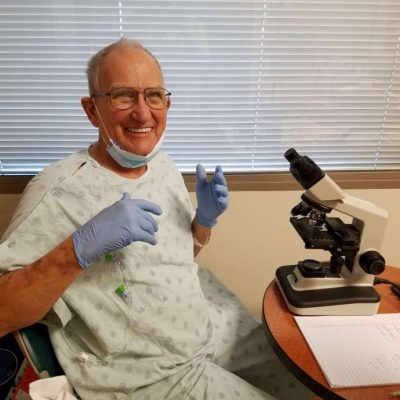 Photo of Vaughn Bryant in his hospital room studying pollen