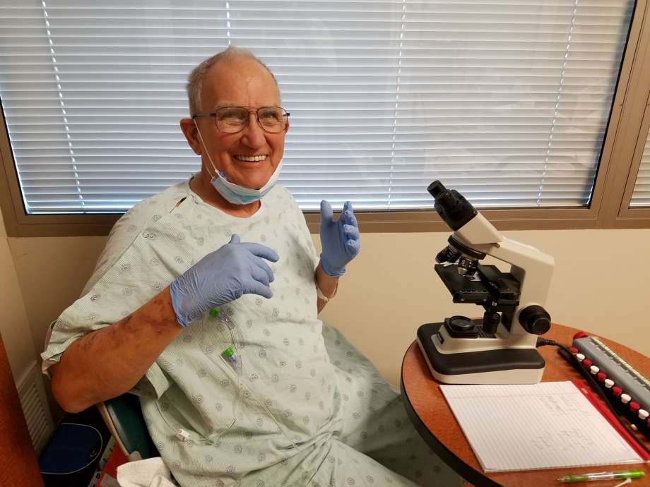 Photo of Vaughn Bryant in his hospital room studying pollen