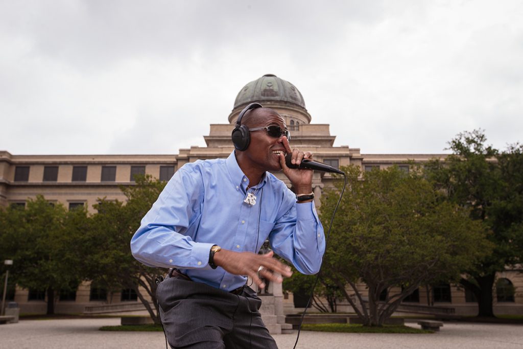 Reuben May rapping in front of the Academic Building
