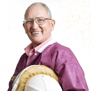 Professor Bryant wearing a maroon coat holding a beekeeper's hat