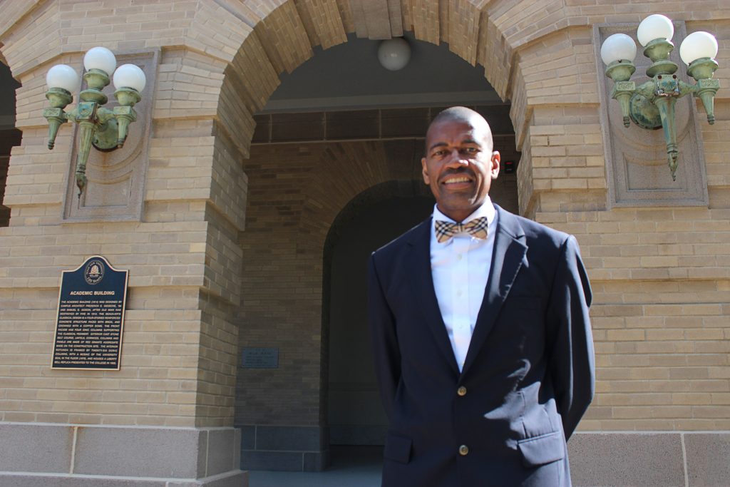 Photo of Reuben May in front of Academic Building