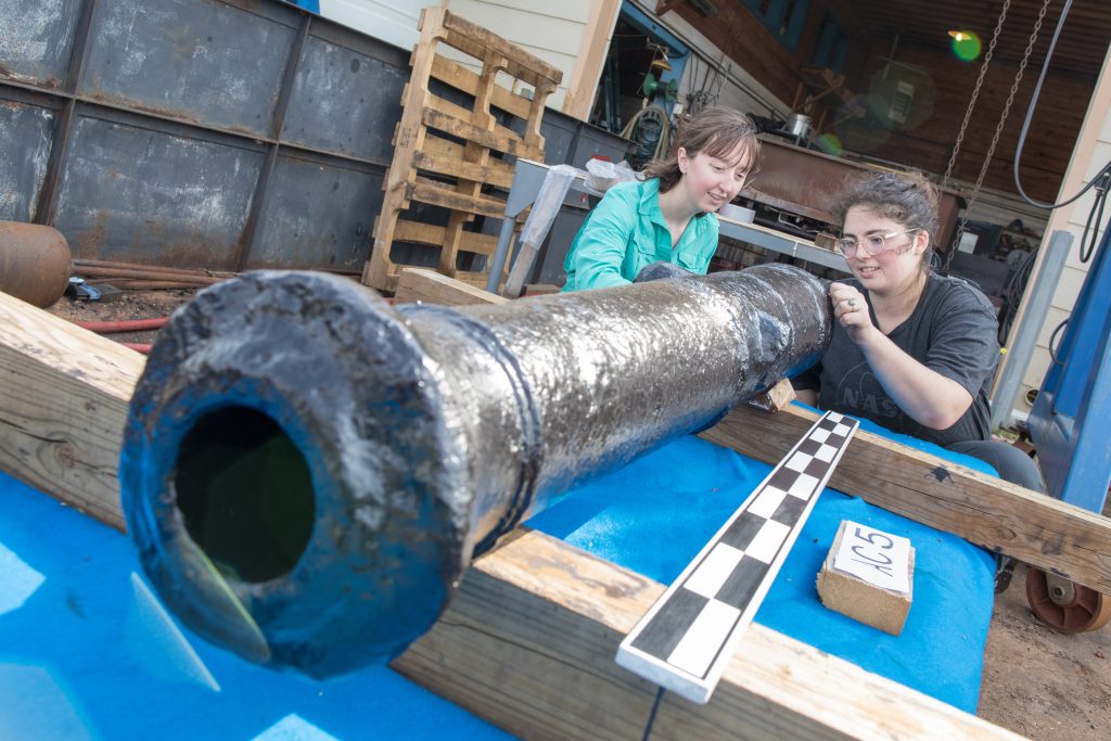 Two female researchers with cannon as it arrives at the Conservation Research Laboratory
