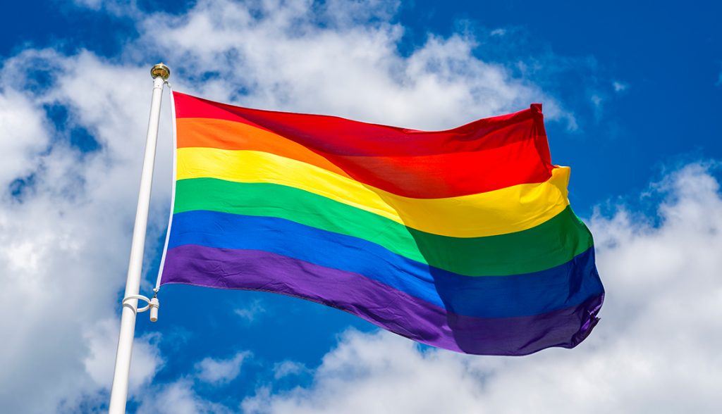 LGBT flag against blue sky