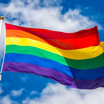 LGBT flag against blue sky