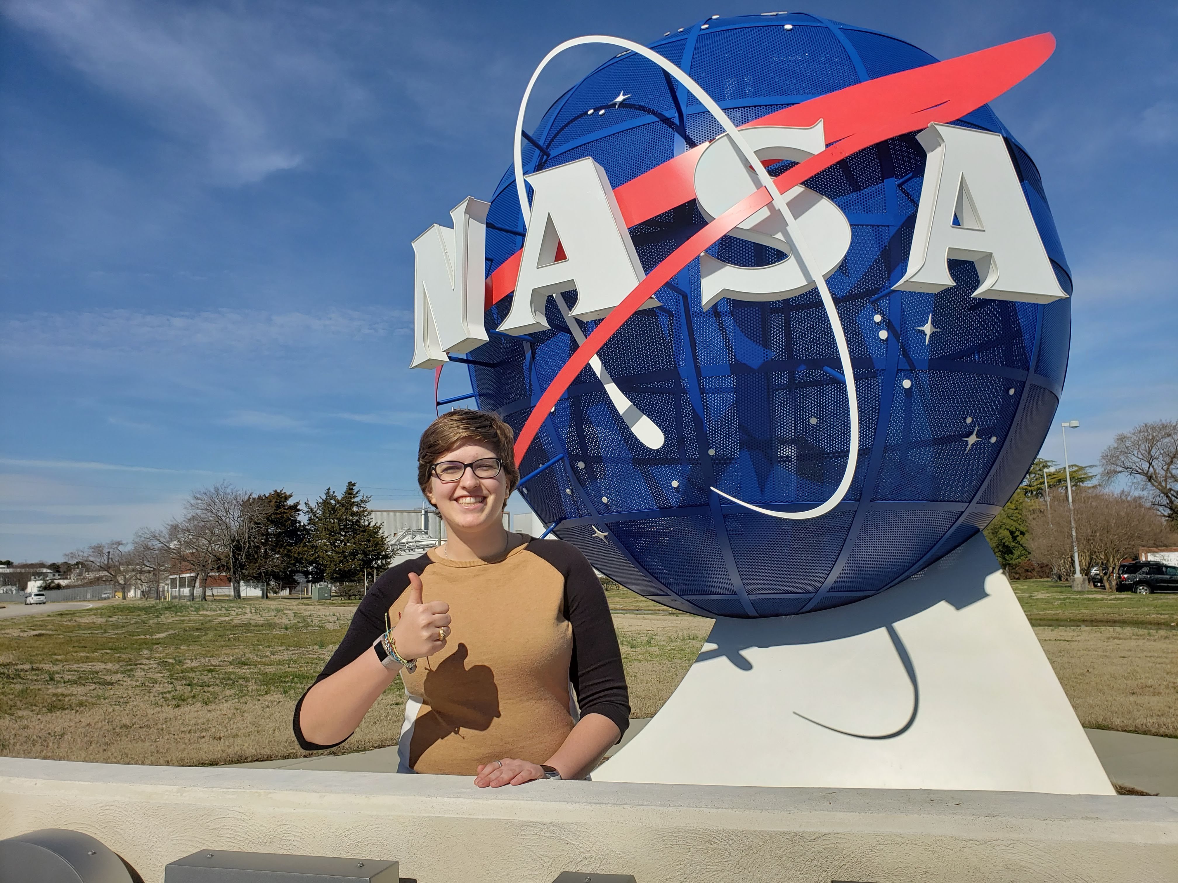 Lloyd in front of a NASA sign.