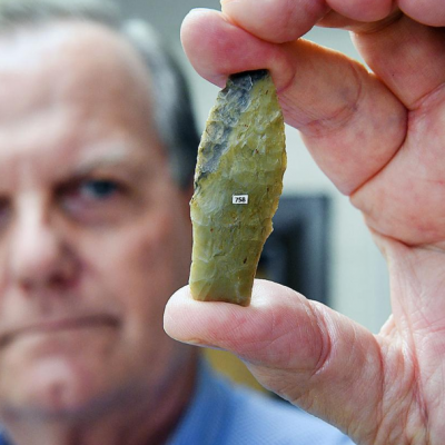 Michael Waters, center director and anthropology professor, holds a replica of a tool dating the arrival of modern humans to North America thousands of years earlier than previously thought.
