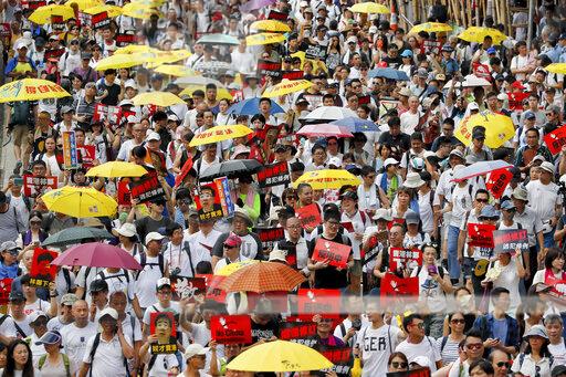 In Asia, umbrellas are commonly used as a form of sun protection. AP Photo/Kin Cheung