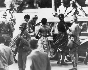 Black students are provided with a military escort when entering and leaving Little Rock Central High School, Arkansas, following the school’s desegregation, 1957. 