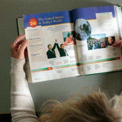 Image of open textbook being read from above