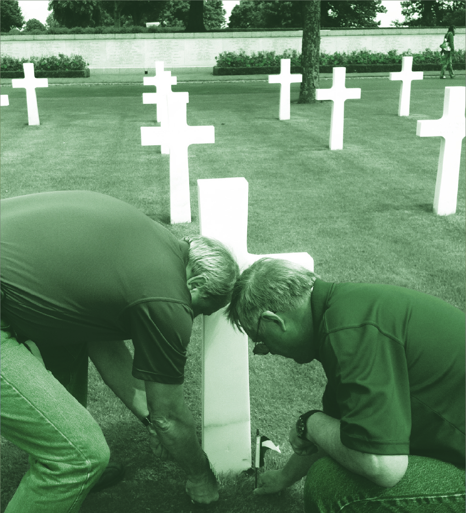 Placing flags on the grave of Col. Wellborn B. Griffith ‘23, an Aggie hero, at the Brittany American Cemetery at  St.  James,  France.  Col.  Griffith  saved  the  800-year-old Medieval Cathedral at Chartres from certain destruction. He is honored by the French every year.