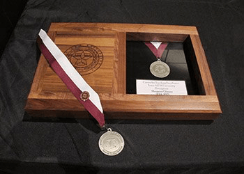 Image of plaque and metal recipients are awarded