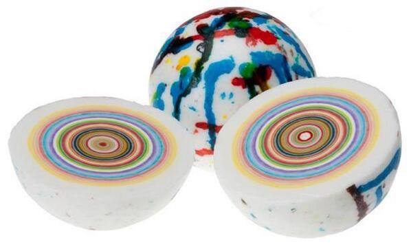 Photo of a jaw breaker split in half to reveal the colorful layers.
