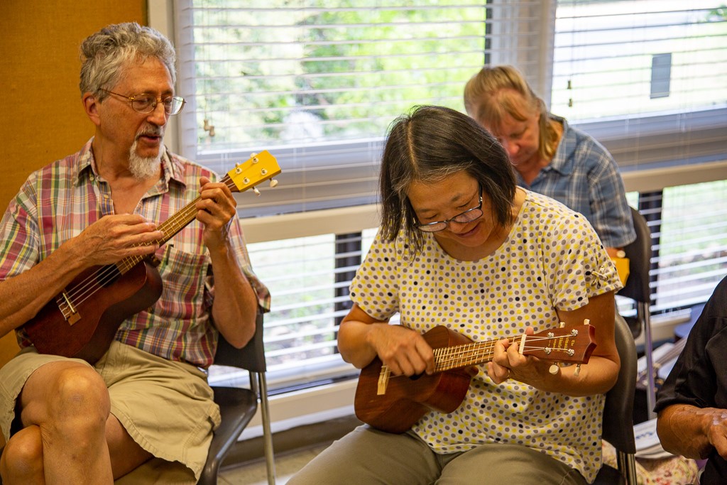 Seniors learn to play a new instrument at a congregate meal program.