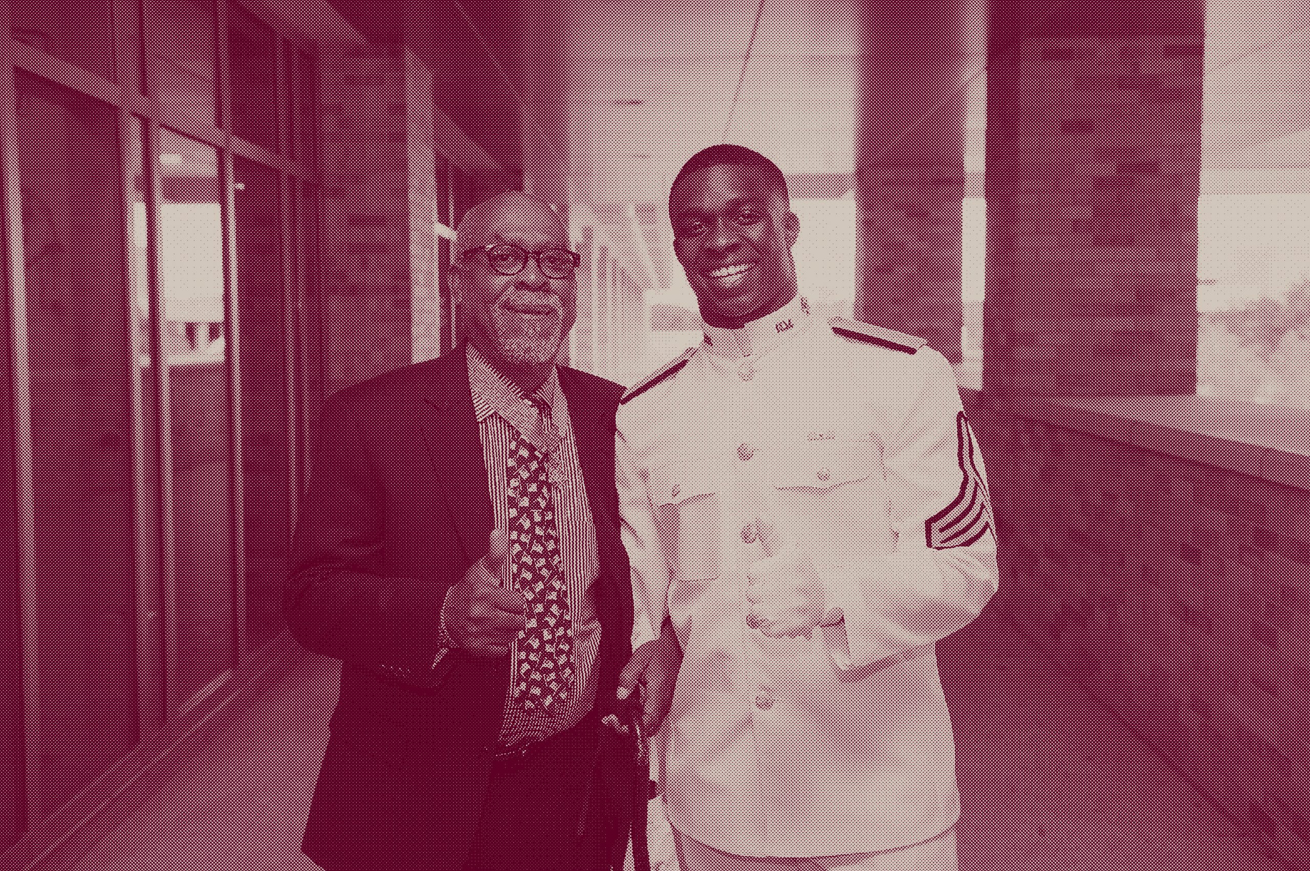 Chris Powell holds up a Gig 'em in his Ross Volunteers uniform as he poses for a photo with Clarence E. Sasser '73, who served as an Army medic in Vietnam and became the eighth Aggie to be awarded the Medal of Honor.
