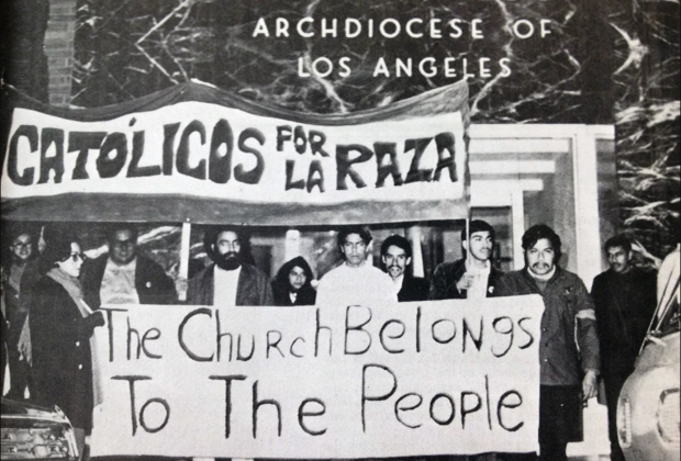 Black and white image of Catolicos por la Raza holding a sign that says, "The Church Belongs To The People."