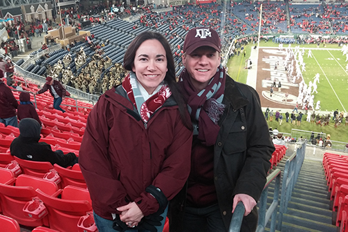 The Brus pose for a photo at a Texas A&M Football game.