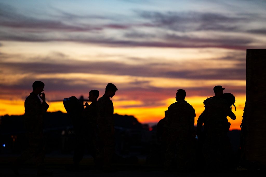 Sun sets behind US Army soldiers preparing to leave Afghanistan.