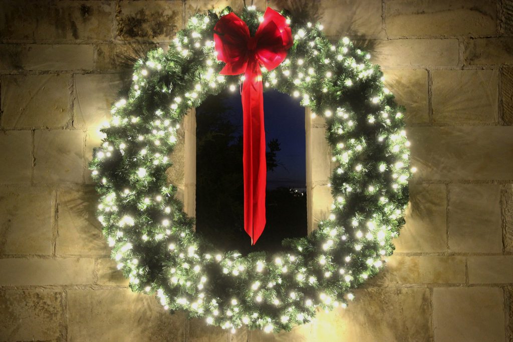 Lighted wreath with red bow.