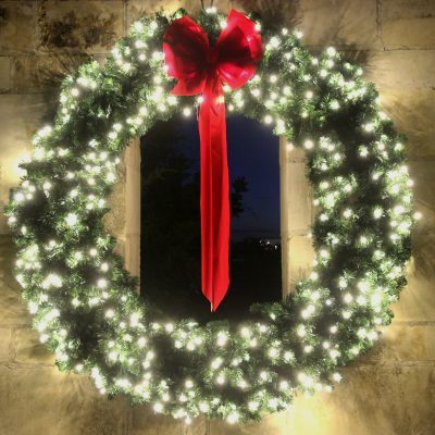 Lighted wreath with red bow.